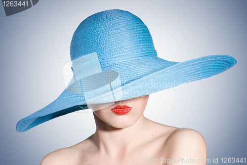 Image of portrait of attractive elegant woman in blue hat