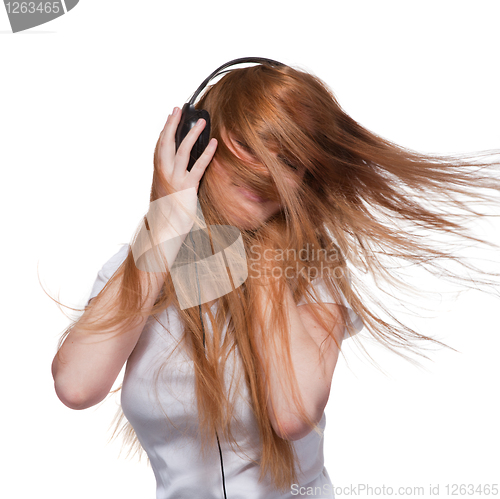 Image of Woman with headphones and hair in motion on white