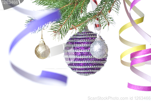 Image of Christmas balls and decoration on fir tree branch isolated on wh