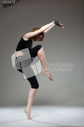 Image of attractive young woman dancing
