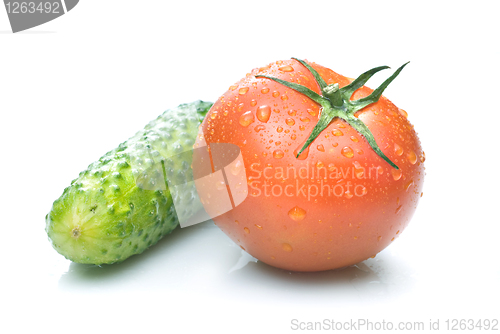 Image of red tomato and green cucumber with water drops isolated on white