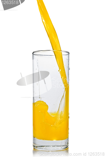 Image of orange juice poring into glass isolated on white