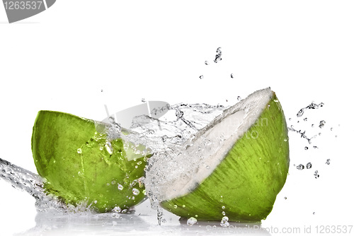 Image of Green coconut with water splash isolated on white