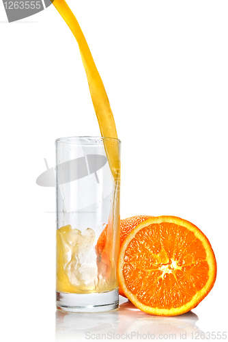 Image of orange juice poring into glass isolated on white