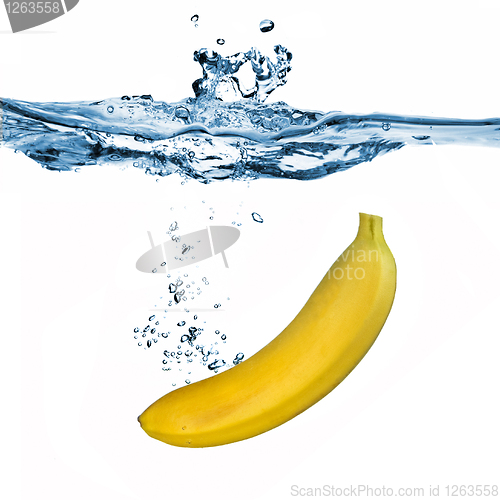 Image of banana dropped into water isolated on white