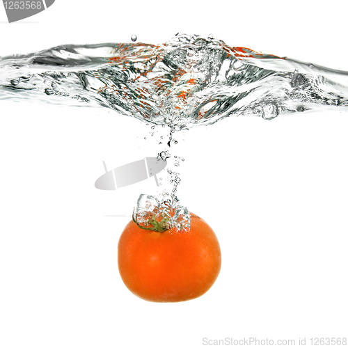 Image of red tomato dropped into water isolated on white