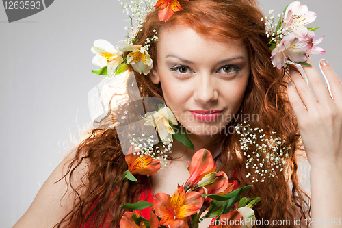 Image of Portrait of beautiful woman with spring flowers