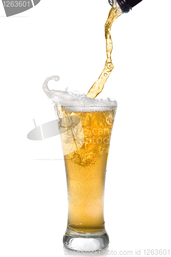 Image of Beer pouring from bottle into glass isolated on white
