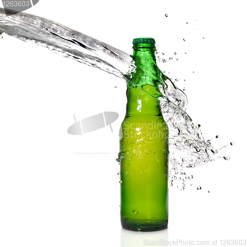 Image of Green beer bottle with water splash isolated on white