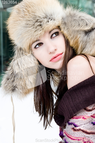 Image of winter portrait of young woman in fur hat