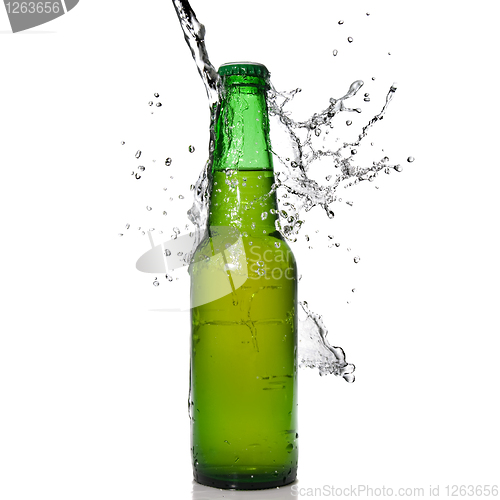 Image of Green beer bottle with water splash isolated on white