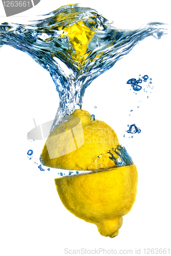 Image of Fresh lemon dropped into water with bubbles isolated on white