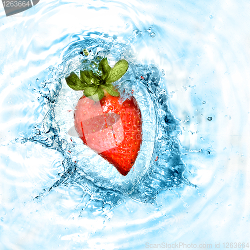 Image of heart from strawberry dropped into water with splash isolated on