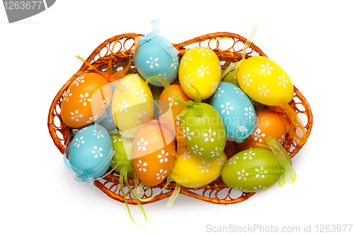 Image of color easter eggs in basket isolated on white. top view