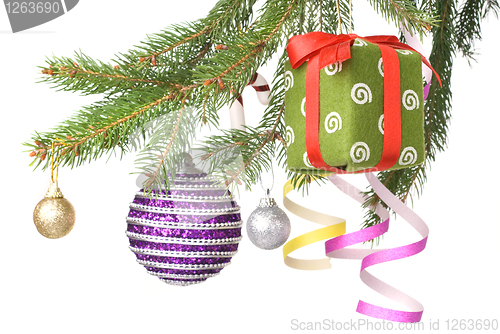 Image of Christmas balls, gift and decoration on fir tree branch isolated