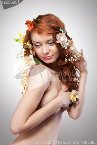 Image of Portrait of beautiful woman with spring flowers 