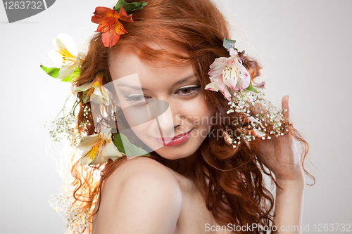Image of Portrait of beautiful naked woman with spring flowers