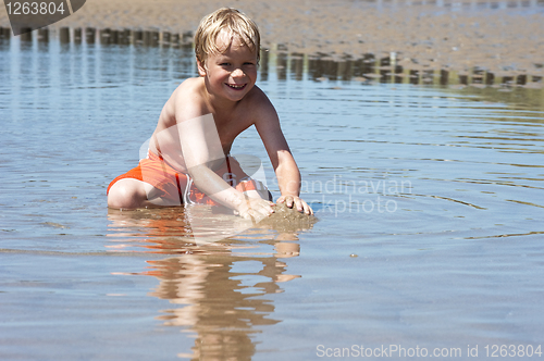 Image of Boy plays with sand