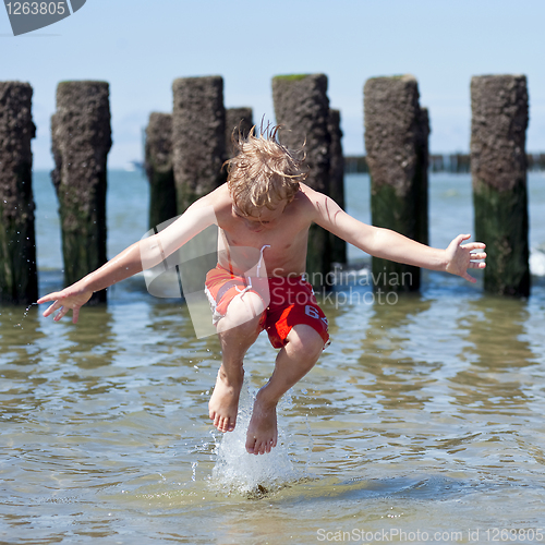 Image of Boy jumps in sea