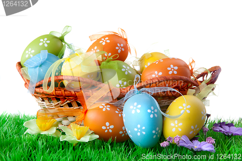 Image of color easter eggs in basket isolated on white