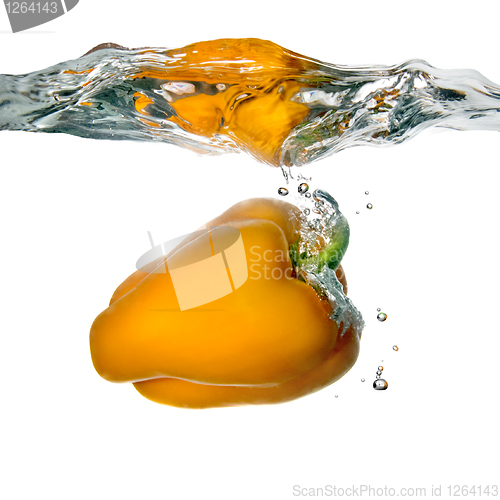 Image of Yellow pepper dropped into water with bubbles isolated on white