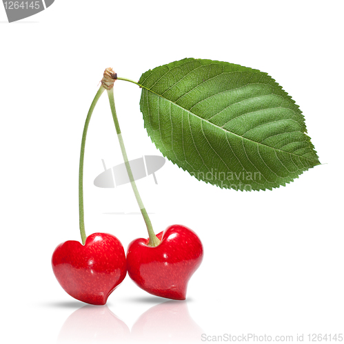 Image of red cherry in shape of heart with leaf isolated on white