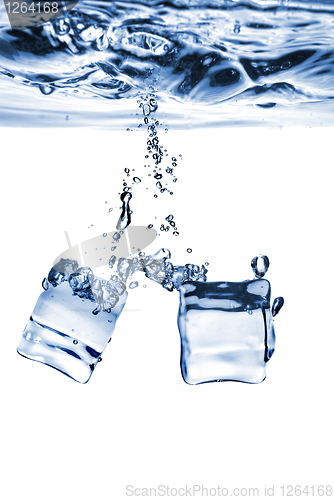 Image of ice cubes dropped into water with bubbles isolated on white