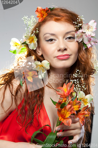 Image of Portrait of beautiful woman with spring flowers