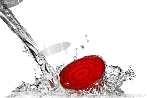 Image of red beet with water splash isolated on white