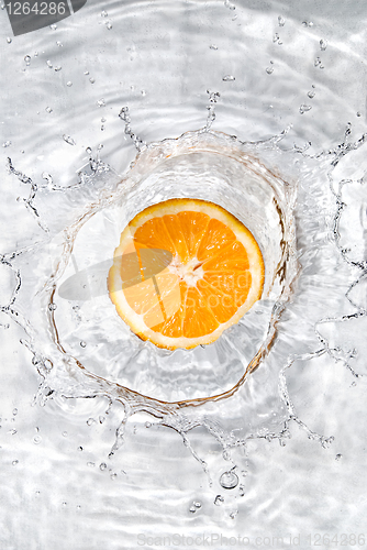 Image of Fresh orange dropped into water with bubbles isolated on white