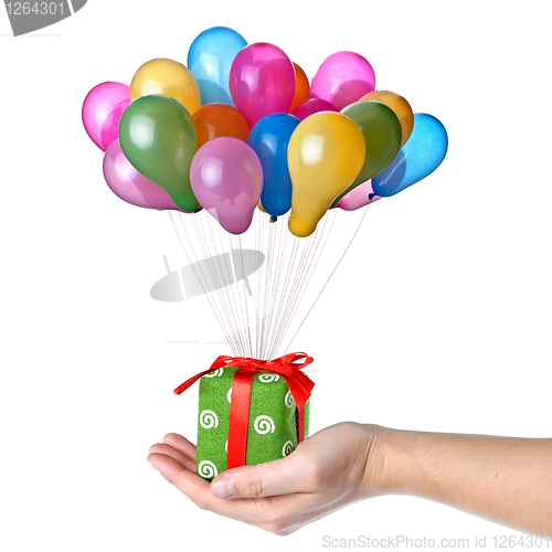 Image of Hand holding gift with color balloons isolated on white