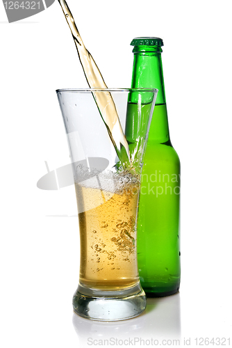 Image of Beer pouring from into glass isolated with bottle on white