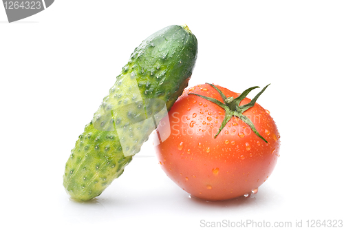 Image of red tomato and green cucumber with water drops isolated on white