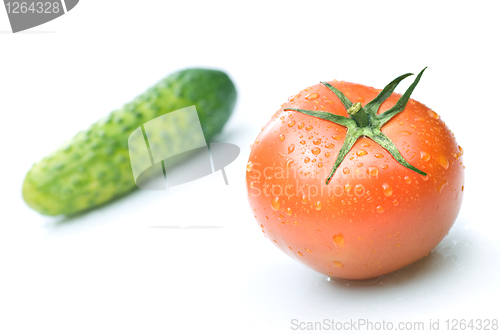 Image of red tomato and green cucumber with water drops isolated on white