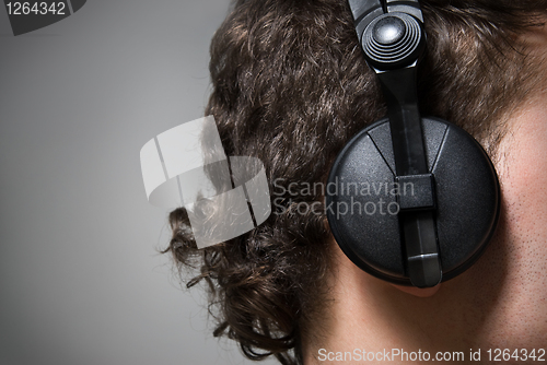 Image of man in headphones listening to music