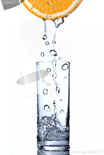 Image of water drops in glass on orange isolated on white