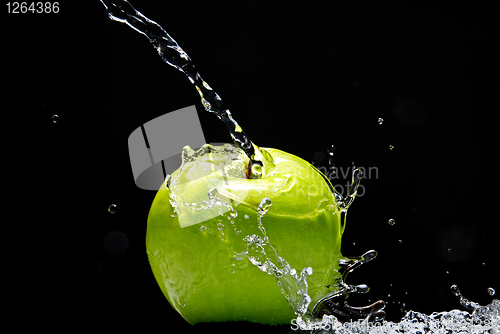 Image of Green apple with water splash on black background