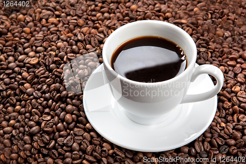 Image of white cup with coffee beans