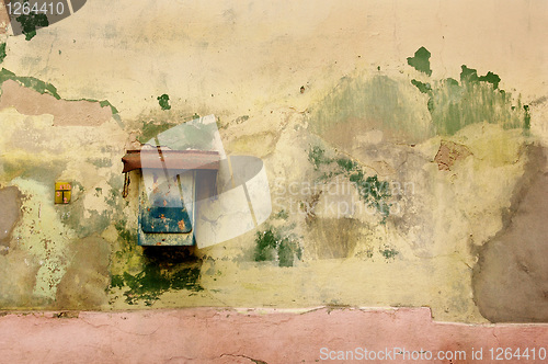 Image of rusty mailbox on old wall