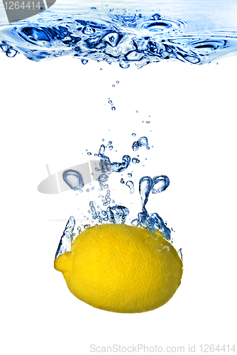 Image of Fresh lemon dropped into water with bubbles isolated on white
