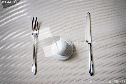 Image of One egg with knife and fork