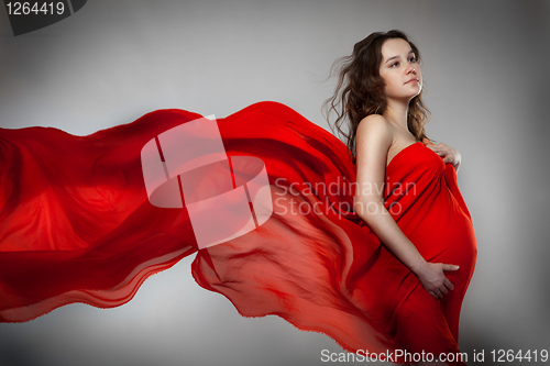 Image of Pregnant woman in red dress 