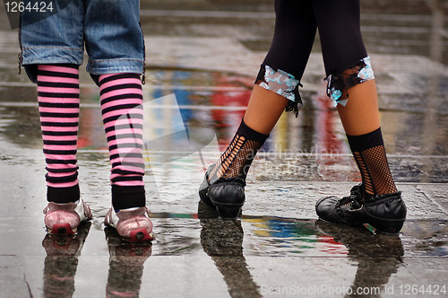 Image of emo shoes standing under the rain