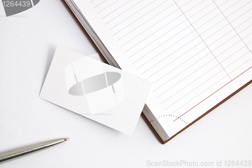 Image of Empty business card with diary and pen isolated on white