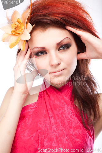 Image of Portrait of beautiful woman with spring flower in hair on white