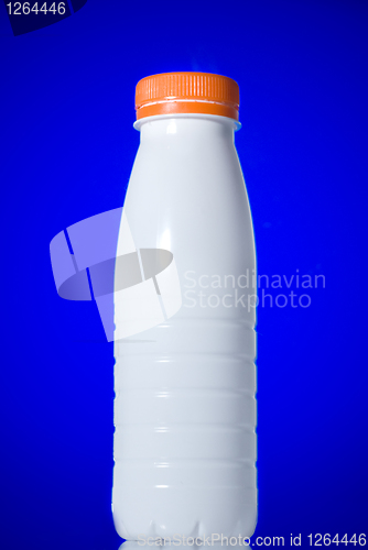 Image of White milk bottle isolated on blue