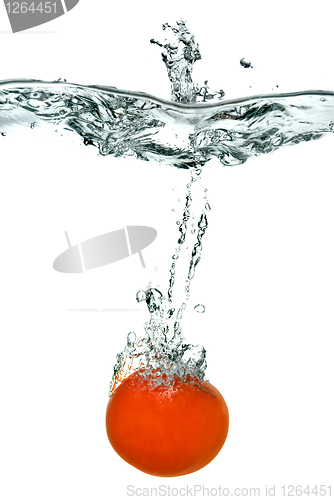 Image of red tomato dropped into water isolated on white