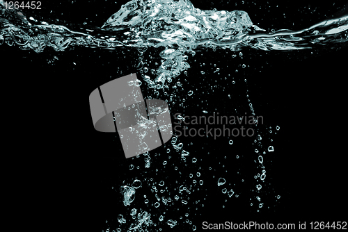 Image of water splash with bubbles isolated on black