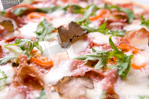 Image of italian pizza with truffels and tomatoes