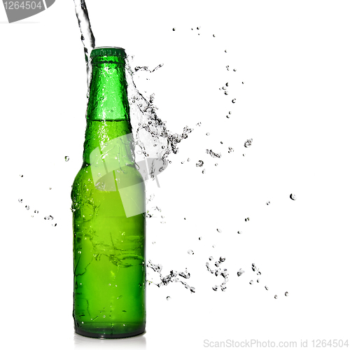 Image of Green beer bottle with water splash isolated on white